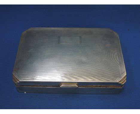 A silver rectangular cigarette box of Art Deco style having engine turned decoration and plain cartouche, marks worn possibly