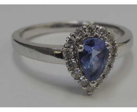 A ladies  dress ring having a pear cut tanzanite within a  diamond surround on an 18ct white gold loop, (with a purchase trad