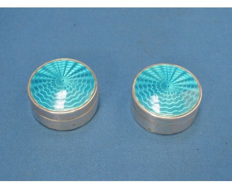 A pair of silver trinket boxes of circular form having blue guilloche enamel decoration to lids,  Birmingham 1909, makers mar