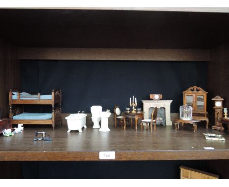 A shelf of Victorian style dollshouse miniatures in 12th scale having dining room, bathroom, child's bedroom etc