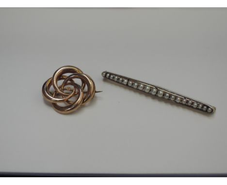 A yellow metal bar brooch stamped 15ct PT having graduated seed pearl decoration and a yellow metal brooch of decorative circ
