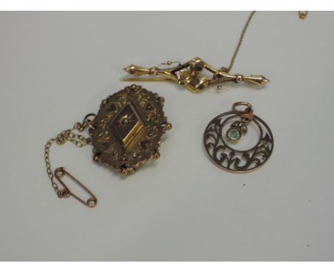 An Edwardian style yellow metal pendant stamped 9ct of open circular form having a central dropper, a Victorian 9ct gold mour