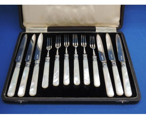 A cased set six silver fruit knives and forks having engraved blades and mother of pearl handles, Sheffield 1929,  Walker & H