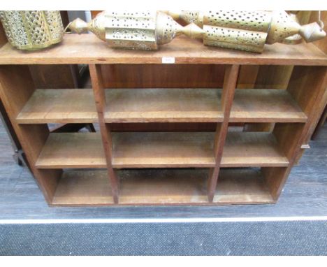 An early 20th century golden oak wall shelf having open shelves