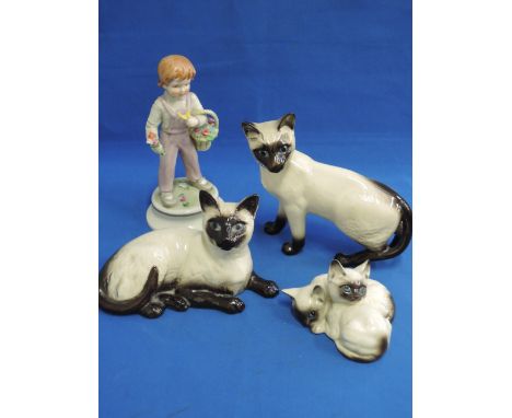 Three Royal Doulton figure modelled as Siamese cats, and a Goebel figure modelled as basket boy, impressed Lore 247/1970
