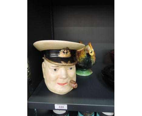 A mid 20th century pottery character jug modelled as Winston Churchill and a 1930's Winton teapot modelled as a Rooster