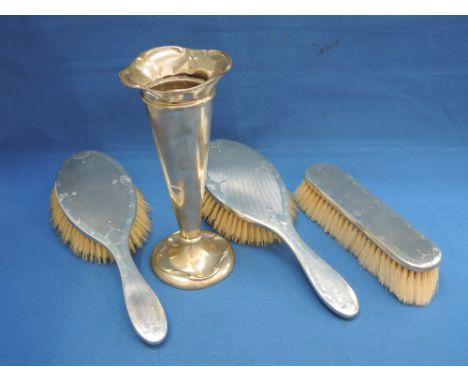 A three piece silver backed brush set having engine turned decoration, London 1947, William Comyns & Sons Ltd, and an HM silv