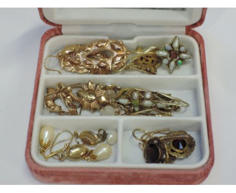 A small case of yellow metal earrings including pearl and opal, stylised etc