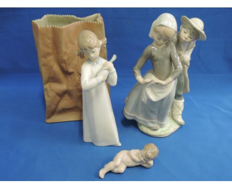 A Rosenthal studio line bisque ornament modelled as a paper bag, a Lladro figure modelled as girl with violin, a similar figu