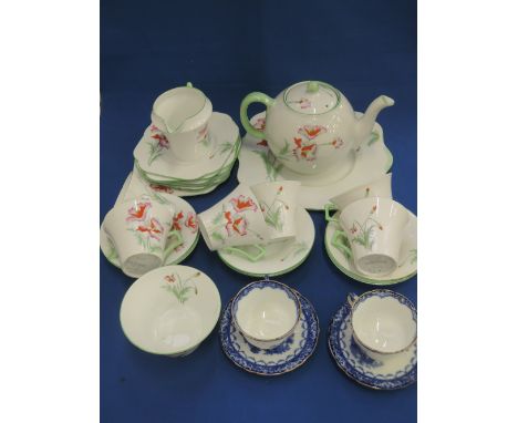 A Colclough tea service of 1920's poppy design and a pair of Royal Doulton tea cups/saucers having pictorial blue decoration