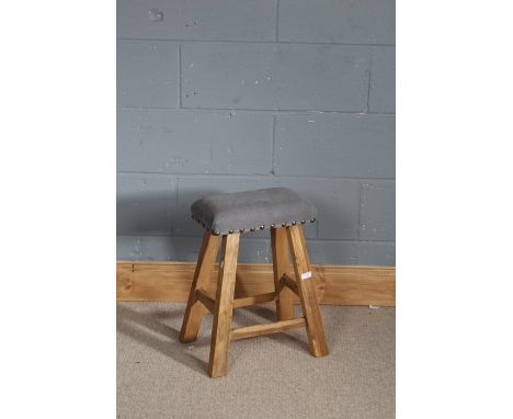 Stripped pine stool, with grey stud work upholstery, raised on four block legs, 51cm high