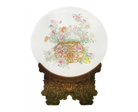 A Chinese famille rose charger, 19th century, of circular form, painted with a finger citron, a peach and flowers spilling fr