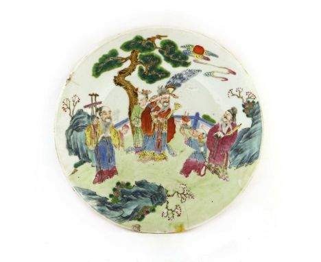 A Chinese famille rose plate, 19th century, of circular form, painted with a boy presenting a jue cup to Fu, Lu, and Shou und