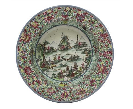 A Chinese famille rose stoneware basin, mid-Qing dynasty, of deep rounded form with a flat everted rim, the interior painted 