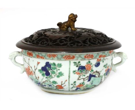 A Chinese famille verte bowl, Kangxi (1662-1722), painted with insects and flowers below a floral border, mask and tongue han
