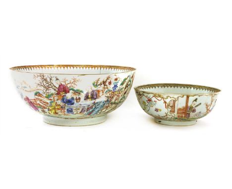Two Chinese famille rose punch bowls, Qianlong (1736-1795), one painted with figures seated around tables in a garden drinkin