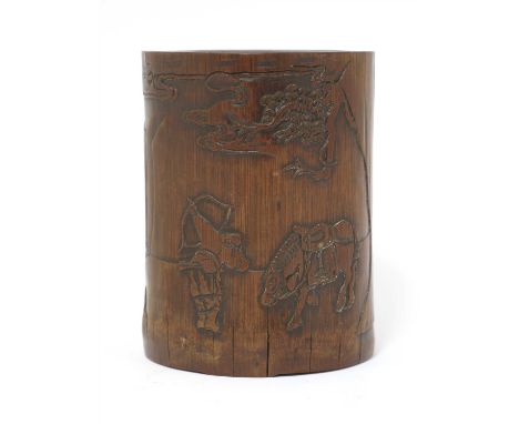 A Chinese bamboo brush pot, early Qing dynasty, carved with a young man drawing a bow to the sky beside a waterfall, his hors