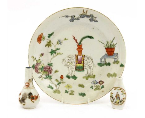 A Chinese famille rose plate, Daoguang (1821-1850), of circular form, painted with an elephant carrying a vase in a garden, w