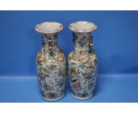 A PAIR OF ORIENTAL VASES DECORATED WITH ENAMEL FLOWERS, BIRDS AND INSECTSSmall chips to top rim of both vases. Gilding worn o