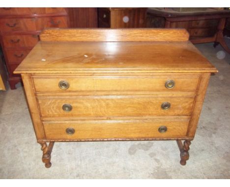 A VINTAGE OAK CHEST OF THREE DRAWERS