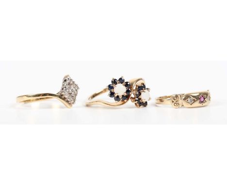 A 9ct gold, opal and sapphire ring in a twin cluster crossover design, London 1973, ring size approx N1/2, a 9ct gold, ruby a