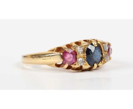 A gold, diamond, sapphire and ruby ring, claw set with a cushion shaped sapphire between two pairs of rose cut diamonds, with