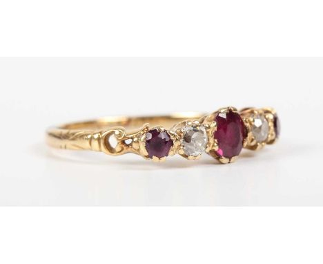 A gold, ruby and diamond five stone ring, claw set with the principal oval cut ruby to the centre, indistinct mark, weight 3g