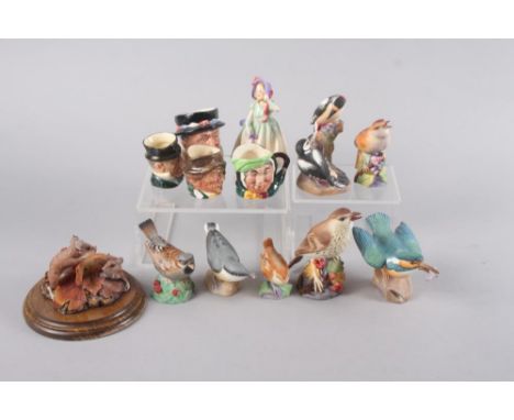 Seven Royal Worcester bone china model birds, including a kingfisher, pied woodpeckers, and a nightingale, a Royal Doulton fi