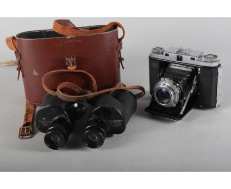 A Zeiss Ikona 35mm camera and a pair of military binoculars, in case 