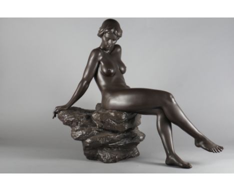 A bronzed Lladro sculpture of a nude woman resting on a rock, base signed "R, Torrijos No 98", 26" high x 19" wide (damage to