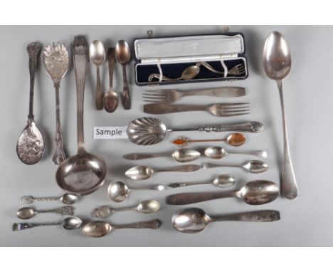 A quantity of silver plated cutlery, including a ladle, a loose canteen of Russian? cutlery, copper spoons, inset amber, and 