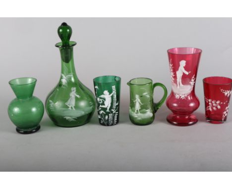 A "Mary Gregory" green decanter with figure decoration, 8 1/2" high, a similar jug and tumbler and a similar ruby glass vase 