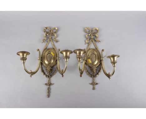 A pair of brass two-light wall brackets of Adam design, 16" high 