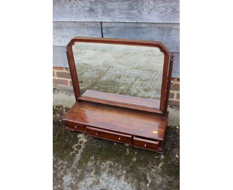 A mahogany swing frame toilet mirror, on plateau base, fitted three drawers on ogee bracket feet, 26" wide x 20" deep x 24" h