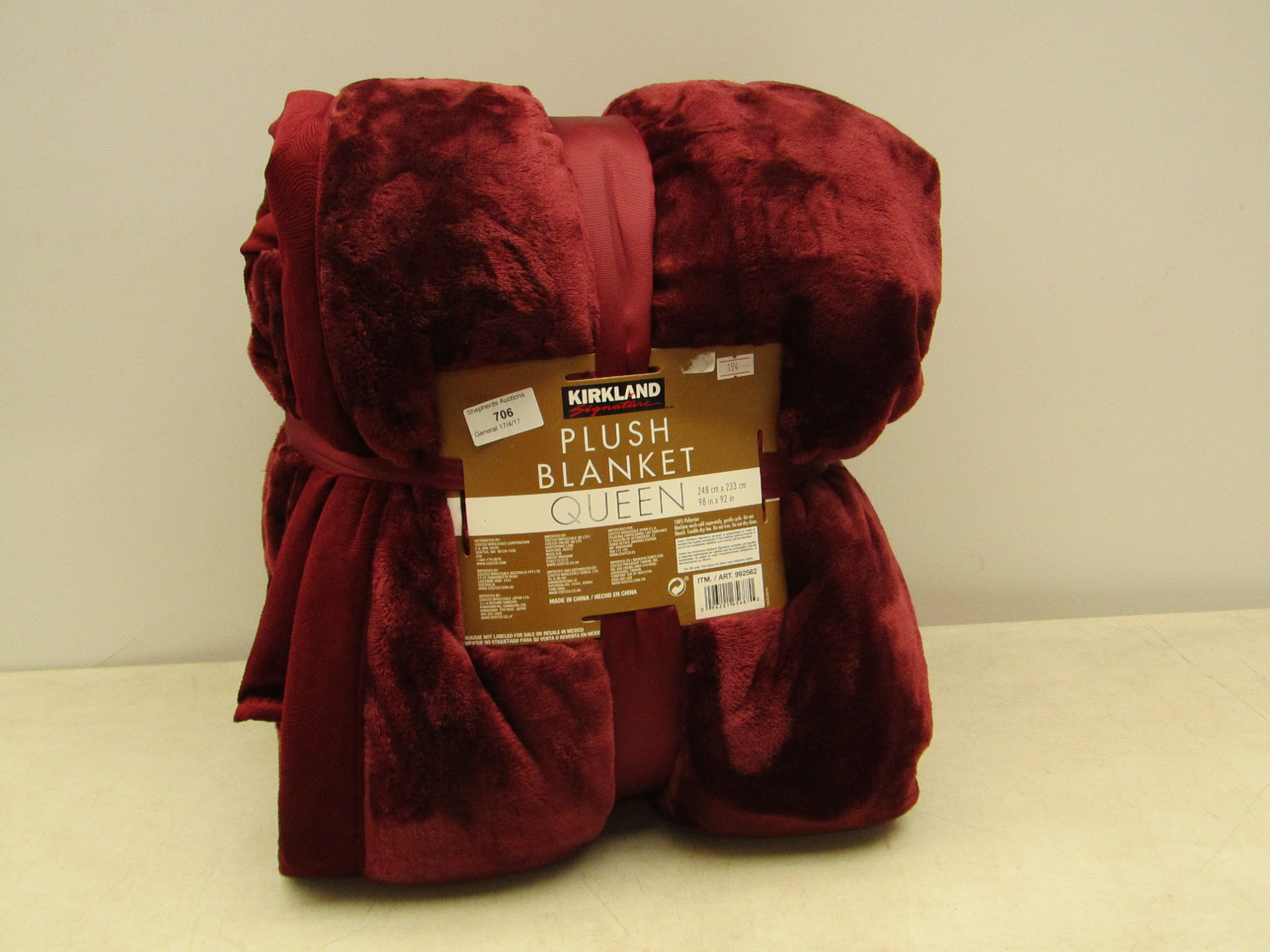 Kirkland signature plush blanket, queen size, in packaging.