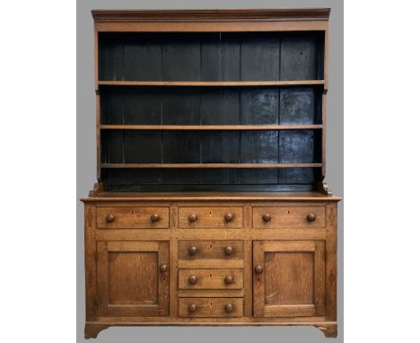 NORTH WALES DRESSER having a three shelf rack over a T-Bank of three over three drawers and two side cupboard doors, all with