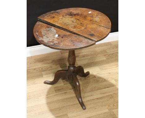 A George III oak tripod occasional table, circular tilting top, slender baluster pillar, cabriole legs, 66cm high, 60cm diame