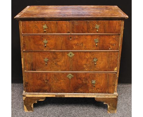 A George II walnut chest of drawers, oversailing rectangular top above two short and three long graduated drawers, bracket fe