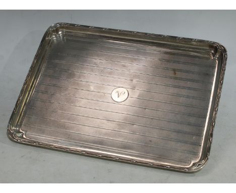 A silver rounded rectangular dressing table tray, engine turned, monogrammed, Birmingham 1938, 28cm x 21cm, approx. 12oz 