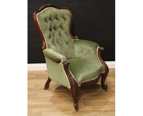A Victorian rosewood drawing room chair, shaped back with carved serpentine cresting, scroll arms, deep-button stuffed over u