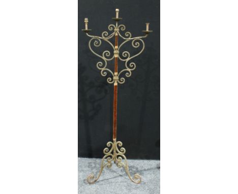A wrought iron floor standing three branch candelabra, 165.5cm high. 