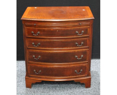 A George III style crossbanded mahogany bow fronted bachelor?s chest, brushing slide above four drawers, bracket feet 