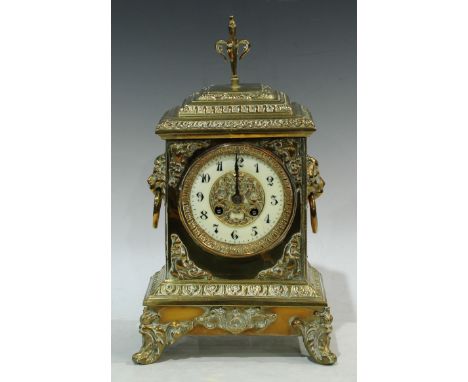 A brass mantel clock, ivorine chapter ring, Arabic numerals, twin winding holes, pair of lion mask handles, striking on a bel