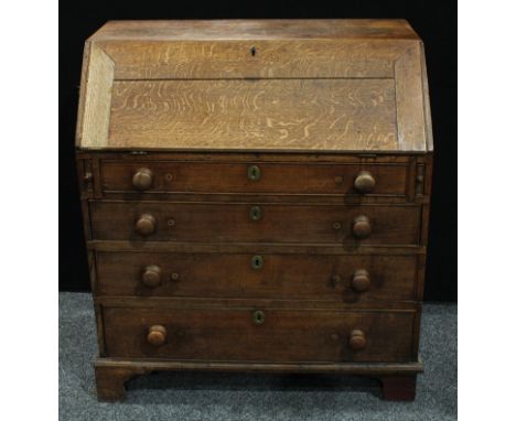 A George III oak bureau, fall front enclosing an arrangement of pigeonholes and small drawers, above four graduated cockbeade