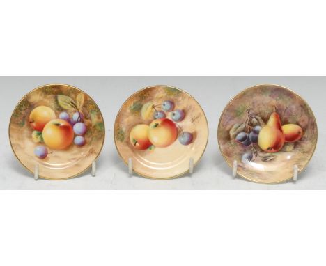 A pair of Royal Worcester circular pin dishes, painted by Roberts, signed, with ripe fruit on a mossy bank, 8.5cm diam, print