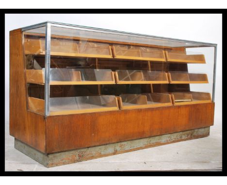 A mid 20th century light oak haberdashery shop display cabinet, the haberdashery unit consists of twelve large&nbsp; graduate