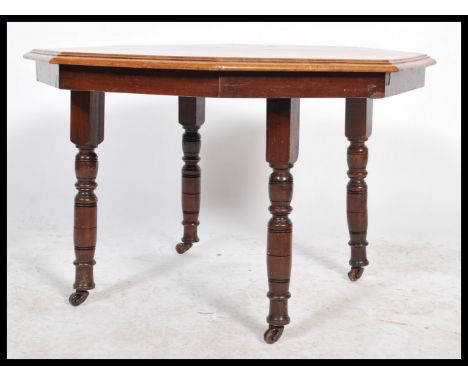 A vintage 20th century Edwardian mahogany octagonal low occasional / coffee table raised on turned legs united by a lower tie