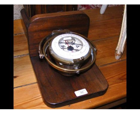 An antique gimbled ship's compass on plaque