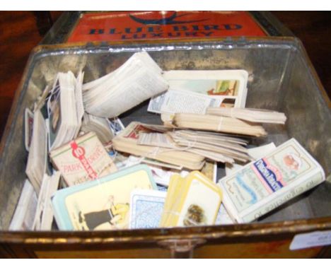 A vintage tin of cigarette cards 
