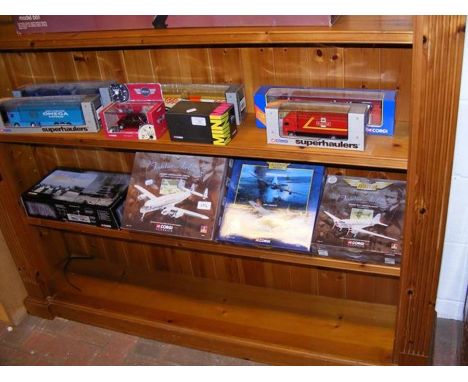 Two shelves of Corgi die cast model vehicles and airliners 